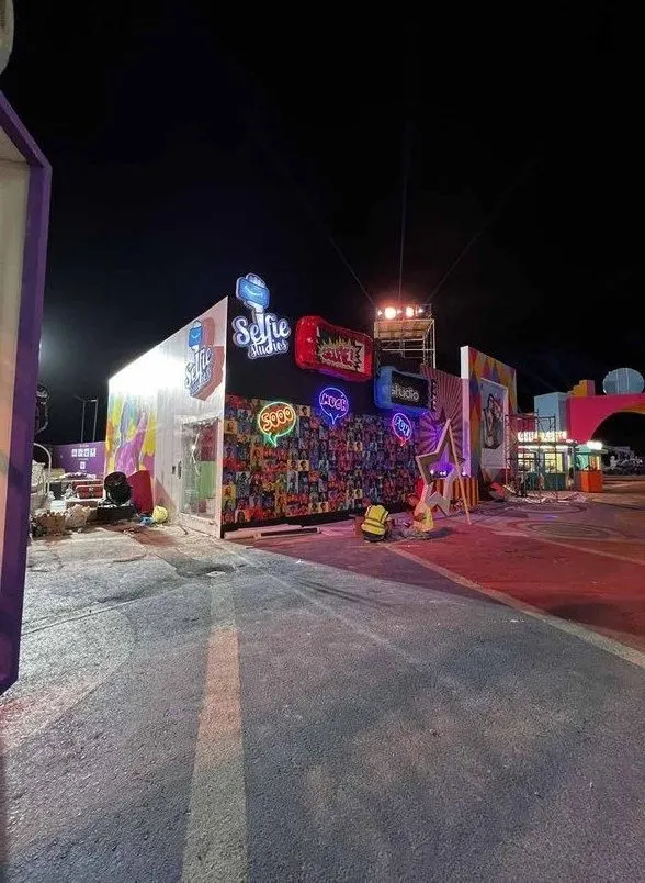 A colourful selfie-studio installation at night