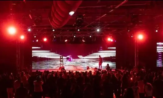 A red-lit stage and crowd