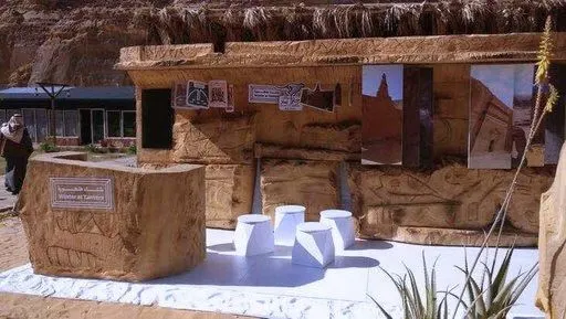 A sandstone-style pavilion with white seating
